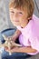 Young boy outdoors holding starfish