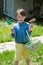 Young Boy Outside Dressed Up for Easter holding Basket