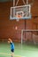 Young boy playing basketball indoors