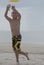 Young boy playing catch on the beach great focus