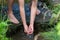 Young boy playing with clear water at a little creek using his hands and the water spring cooling his hands plus refreshing