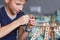 Young boy playing with eco wooden constructor