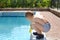 Young boy playing at the edge of a swimming pool