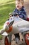 Young boy playing outdoors in airplane smiling