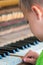 Young boy playing on the piano