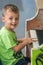 Young boy playing on the piano