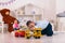 young boy playing toy trucks sitting on the floor in the children`s room