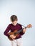 Young boy playing the ukelele