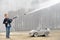 A young boy plays with a car wash hose