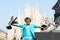 Young boy posing with pigeons in the milanese street with ancient church Duomo di Milano on background. Cute happy 6 years old boy