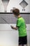 Young boy practising accurate badminton serve