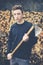 Young boy prepares firewood with axe