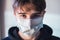 Young boy with protective mask infection fear concept - quarantine at home