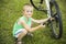 Young boy pumping thÑƒ bicycle tube