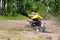 A young boy on a quad does spins in the dirt
