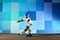 Young boy on roller skates making slide against the blue graffiti wall