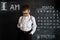 Young boy`s standing near blackboard checking thermometer. Young doctor. Creative design concept for 2019 calendar