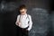 Young boy`s standing near blackboard checking thermometer. Young doctor. Creative design concept for 2019 calendar.