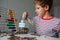 Young boy saving money for education, child put coins into jar