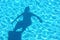Young boy shadow diving in the swimming pool