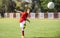 Young boy shooting soccer ball