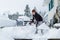 Young boy shoveling snow