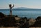 Young boy silhouette on sea beach rocks