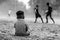 Young boy sitted wathing street soccer game