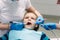 Young boy sitting on the dental chair at the office. Children`s dentist examination baby teeth