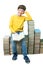 Young boy sitting on stacks of books and reading