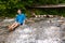 Young Boy Sitting in a Waterfall