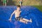 Young boy sliding down a slip and slide outdoors