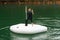 A young boy sowing peace sign standing on the inflatable boat in Kenyir Lake, Malaysia.