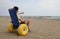 Young boy on the special wheelchair with big inflatable wheels t