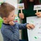 Young boy in speech therapy office. Preschooler exercising correct pronunciation with speech therapist. Child Occupational Therapy