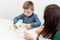 Young boy in speech therapy office. Preschooler exercising correct pronunciation with speech therapist. Child Occupational Therapy