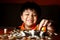 Young Boy Stacking or Piling Coins