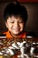 Young Boy Stacking or Piling Coins