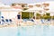 Young boy standing at the pool at tropic resort