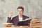 Young boy student sitting near the table with books in glasses. Guy want learning, have education. online education. Study in