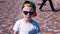 Young boy in sunglasses and a cap walking down the street, Child 6 year old kid walking, slow motion