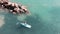 Young boy on sup. Attractive man surfing. Aerial view of sun-tanned boy floating on surfboard. Drone shot of blue clear water and