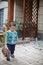 Young boy sweeping leaves