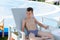 Young boy in a swimsuit on a shelf by the pool