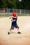 Young Boy Swinging Baseball Bat at Ball in Youth Ragball Game