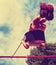 Young boy swinging in a playground toned with a vintage retro