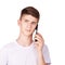 Young boy talking telephone. White shirt at grey background. Male people