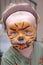 Young boy or toddler covered in Tiger face paint