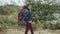 Young boy with a tourist backpack on the beach