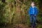 Young boy tourist in New Zealand rain forest